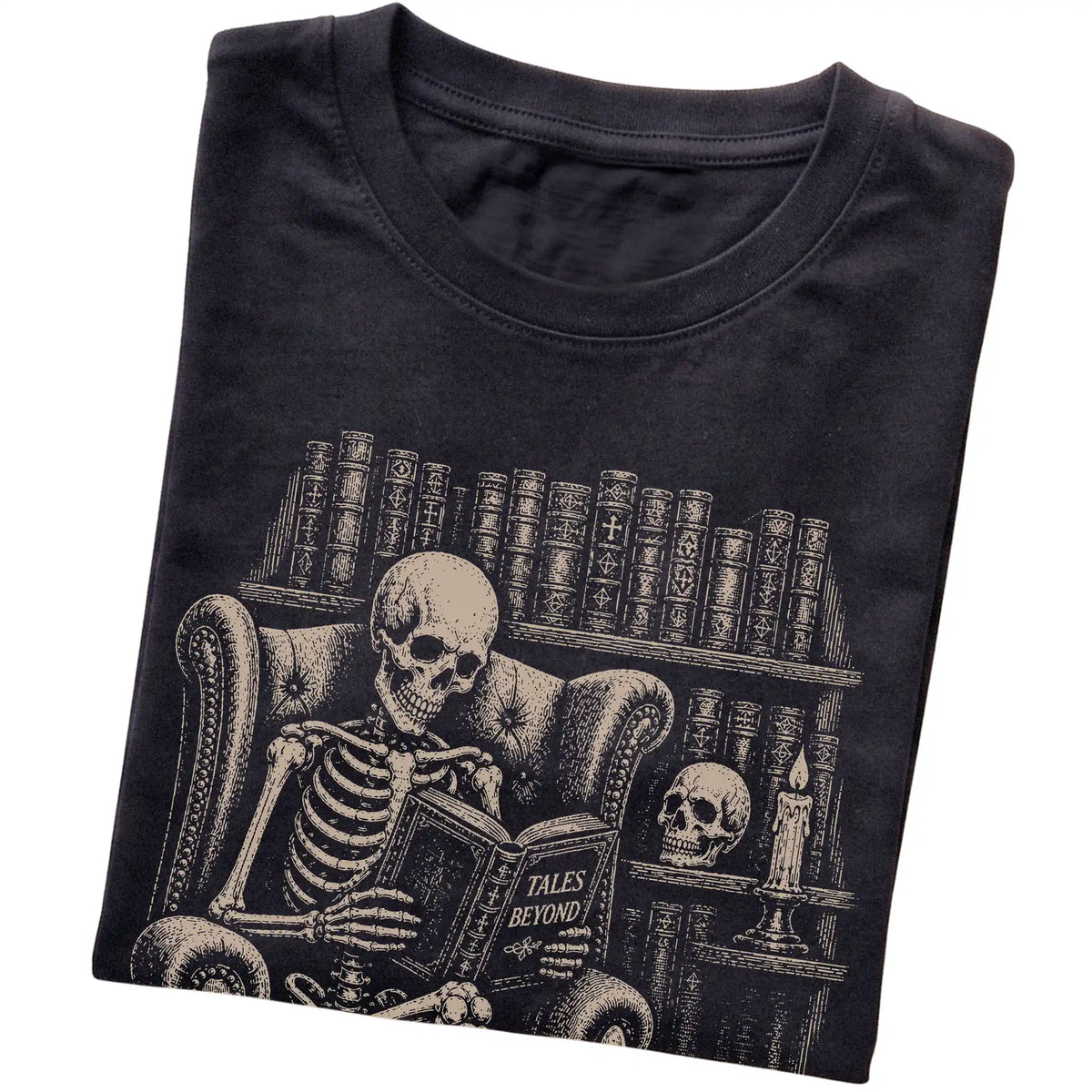 Folded Black T-shirt with a skeleton reading Tales Beyond to a Corgi
