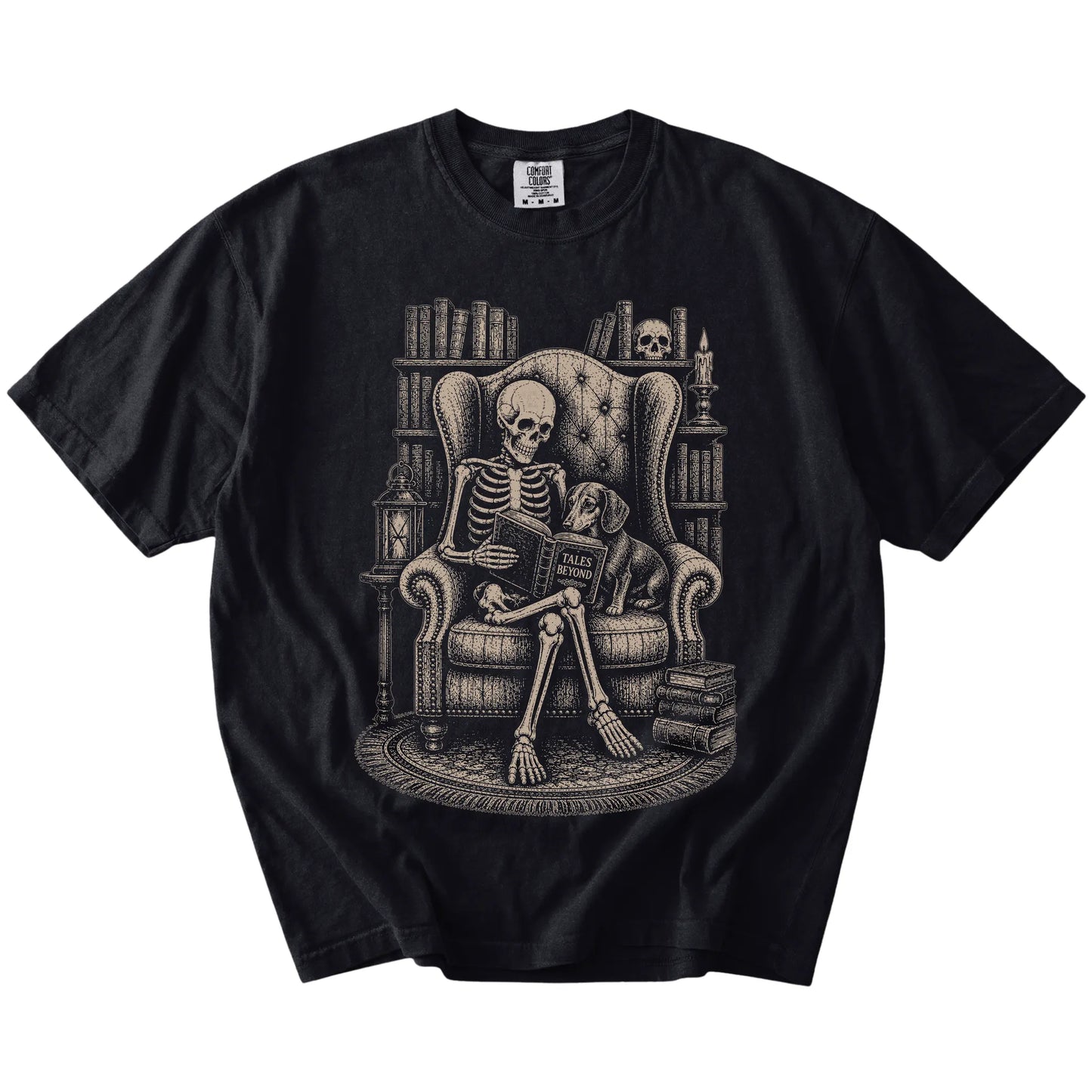 Skeleton reading in a library beside a Dachshund on a Black Comfort Colors® T-shirt