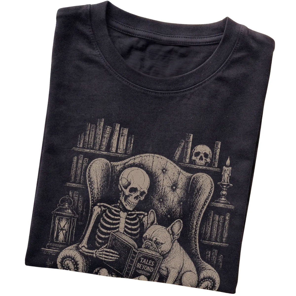 Folded Black T-shirt with a skeleton reading Tales Beyond to a French Bulldog