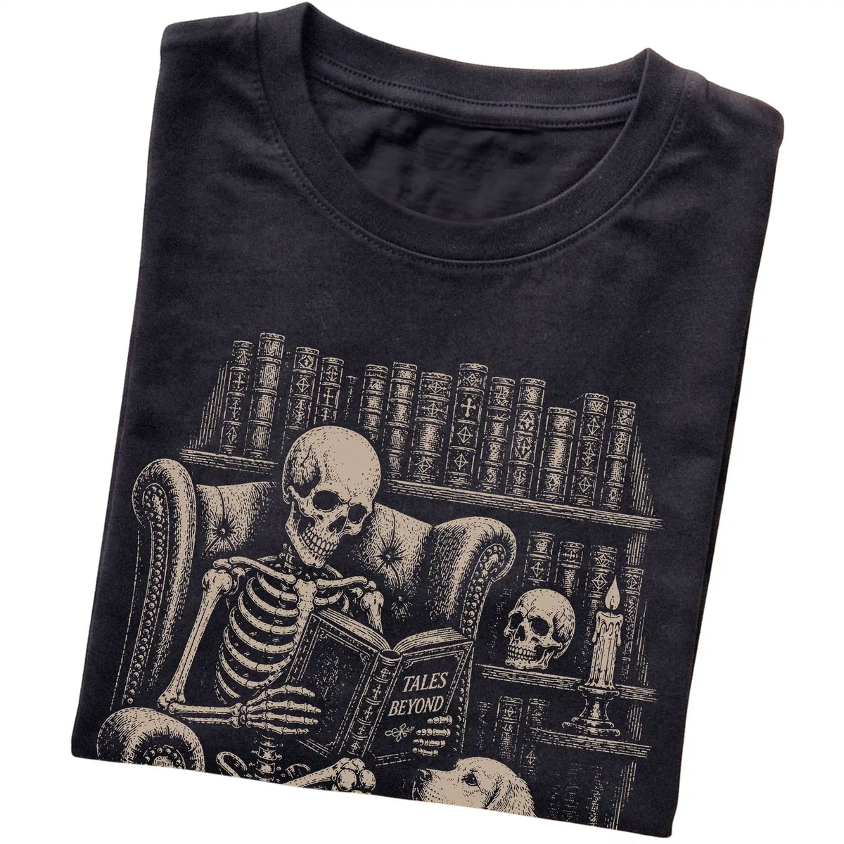 Folded Black T-shirt with a skeleton reading Tales Beyond to a Golden Retriever