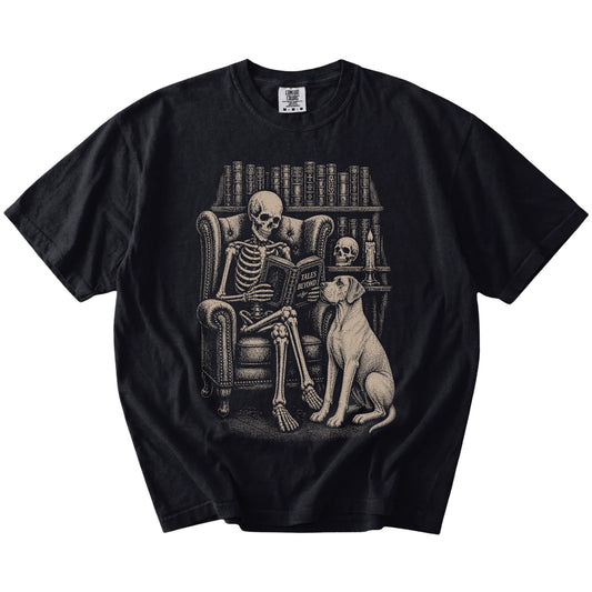 Skeleton reading in a library beside a Great Dane on a Black Comfort Colors® T-shirt