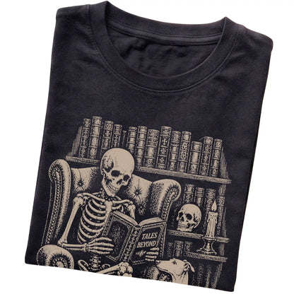 Folded Black T-shirt with a skeleton reading Tales Beyond to a Greyhound