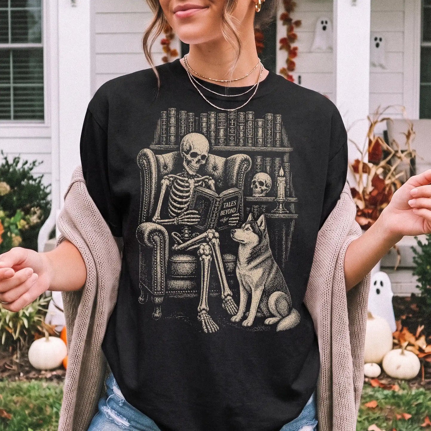 Model wearing a Black Comfort Colors® T-shirt showing skeleton reading in a library beside a Husky