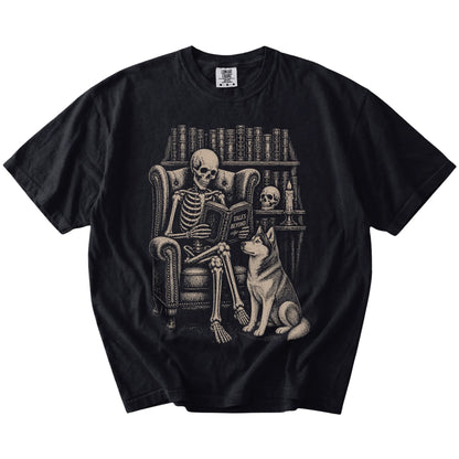 Skeleton reading in a library beside a Husky on a Black Comfort Colors® T-shirt