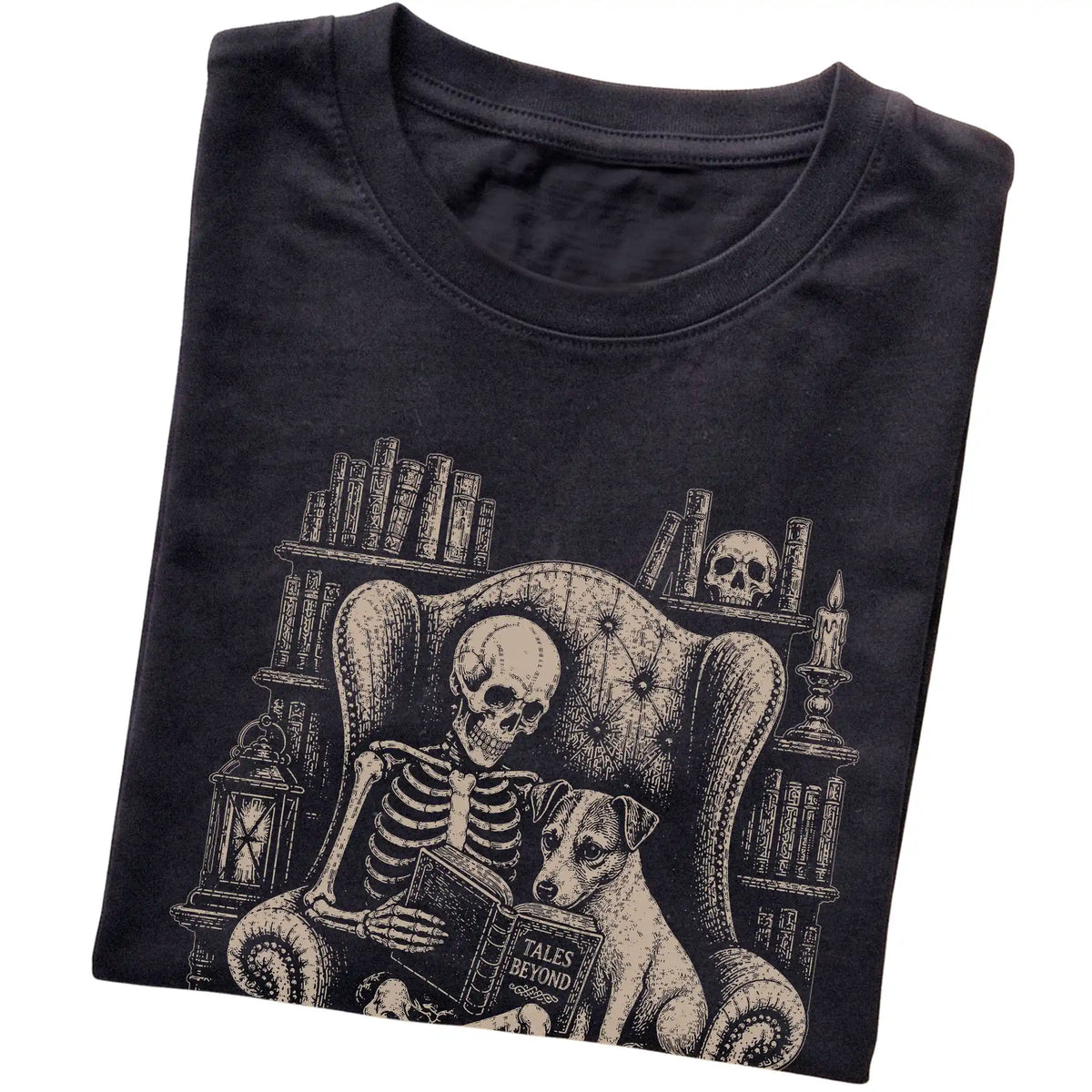 Folded Black T-shirt with a skeleton reading Tales Beyond to a Jack Russell