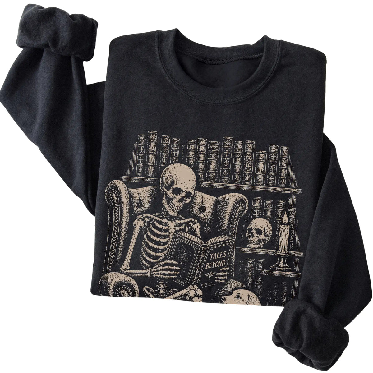 Folded Black sweatshirt with a skeleton reading Tales Beyond to a Labrador Retriever