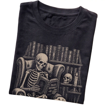Folded Black T-shirt with a skeleton reading Tales Beyond to a Labrador Retriever
