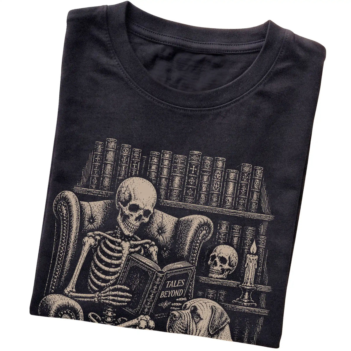 Folded Black T-shirt with a skeleton reading Tales Beyond to a Mastiff