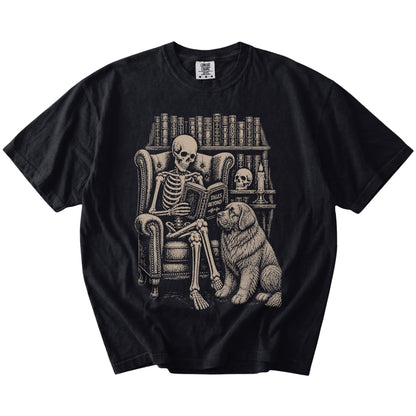 Skeleton reading in a library beside a Newfie on a Black Comfort Colors® T-shirt