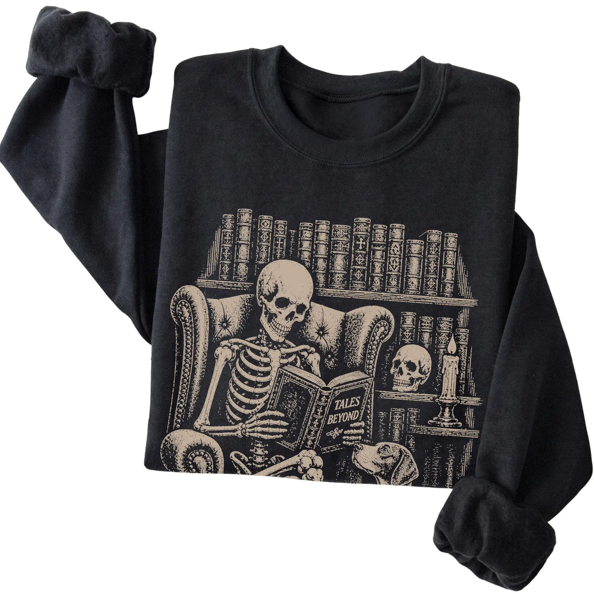 Folded Black sweatshirt with a skeleton reading Tales Beyond to a Pointer