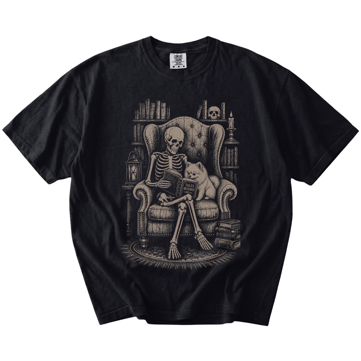 Skeleton reading in a library beside a Pomeranian on a Black Comfort Colors® T-shirt