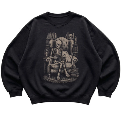 Skeleton reading Tales Beyond to a Pomeranian on a Black sweatshirt