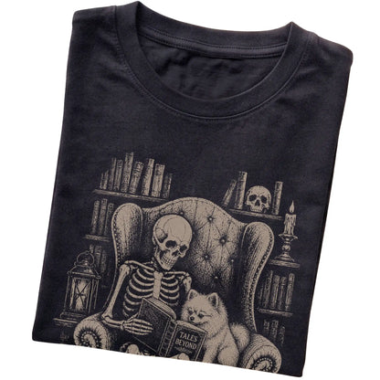 Folded Black T-shirt with a skeleton reading Tales Beyond to a Pomeranian