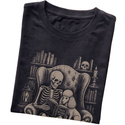 Folded Black T-shirt with a skeleton reading Tales Beyond to a Poodle