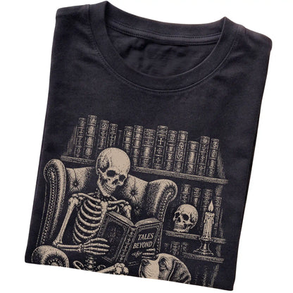 Folded Black T-shirt with a skeleton reading Tales Beyond to a Saint Bernard