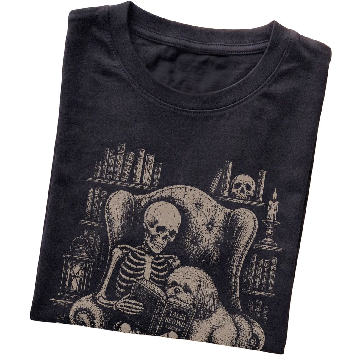 Folded Black T-shirt with a skeleton reading Tales Beyond to a Shih Tzu