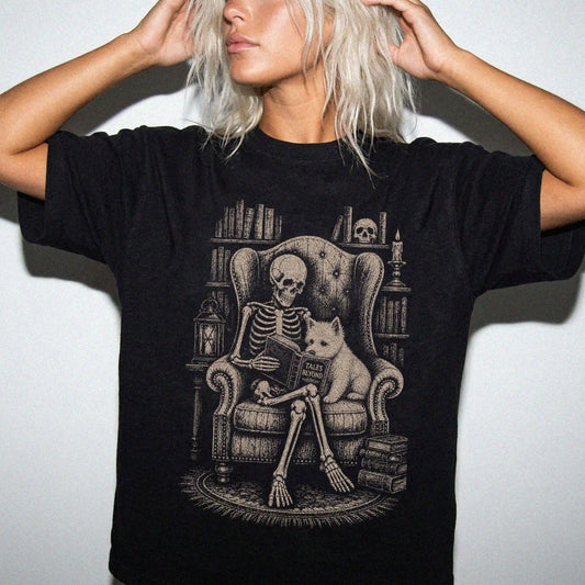 Model wearing a Black Comfort Colors® T-shirt showing skeleton reading in a library beside a Westie