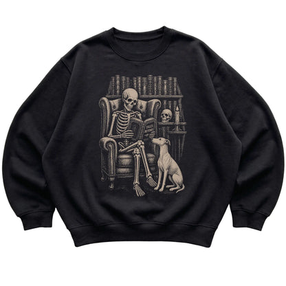 Skeleton reading Tales Beyond to a Whippet on a Black sweatshirt