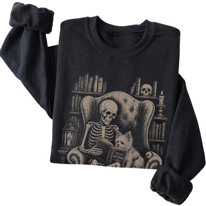 Folded Black sweatshirt with a skeleton reading Tales Beyond to a Yorkie