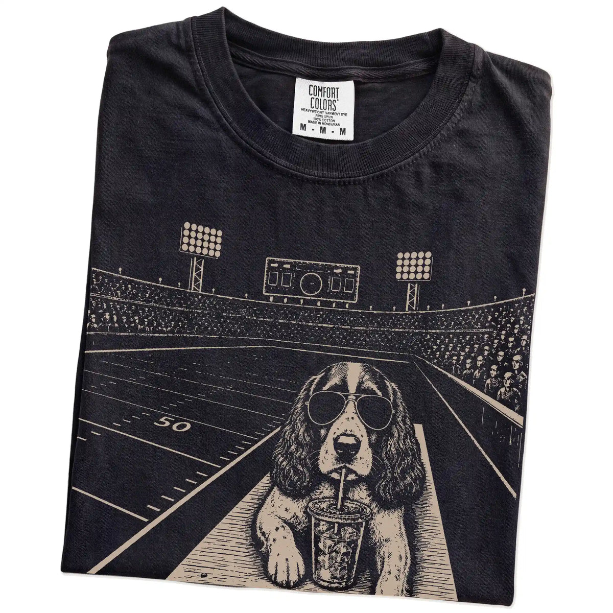 Folded Black Comfort Colors® T-shirt showing Springer Spaniel ready for football and tailgate season