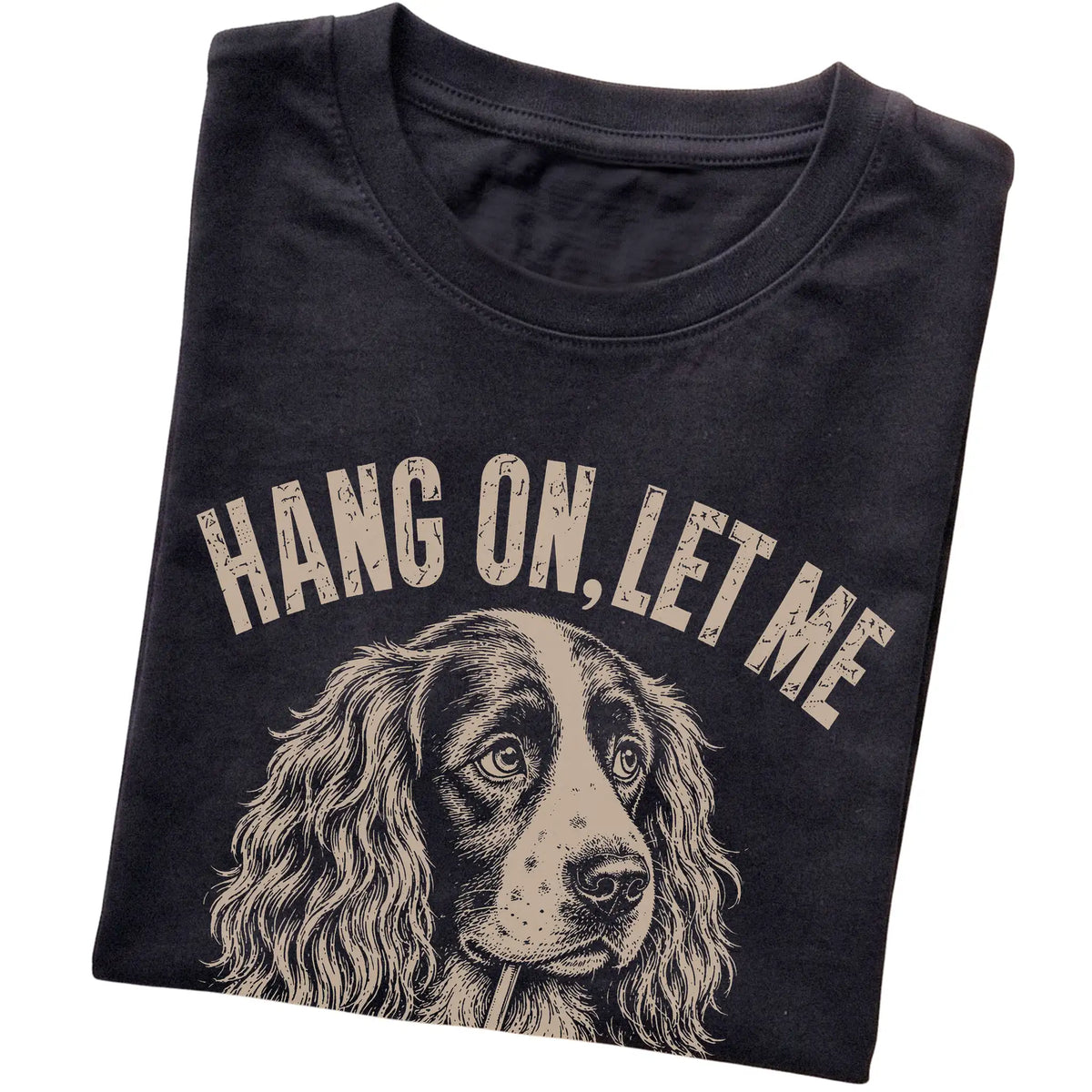 Black T-shirt featuring Overthinking Springer Spaniel, folded presentation