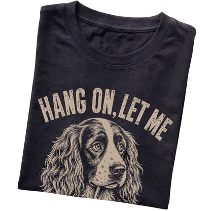 Black T-shirt featuring Overthinking Springer Spaniel, folded presentation