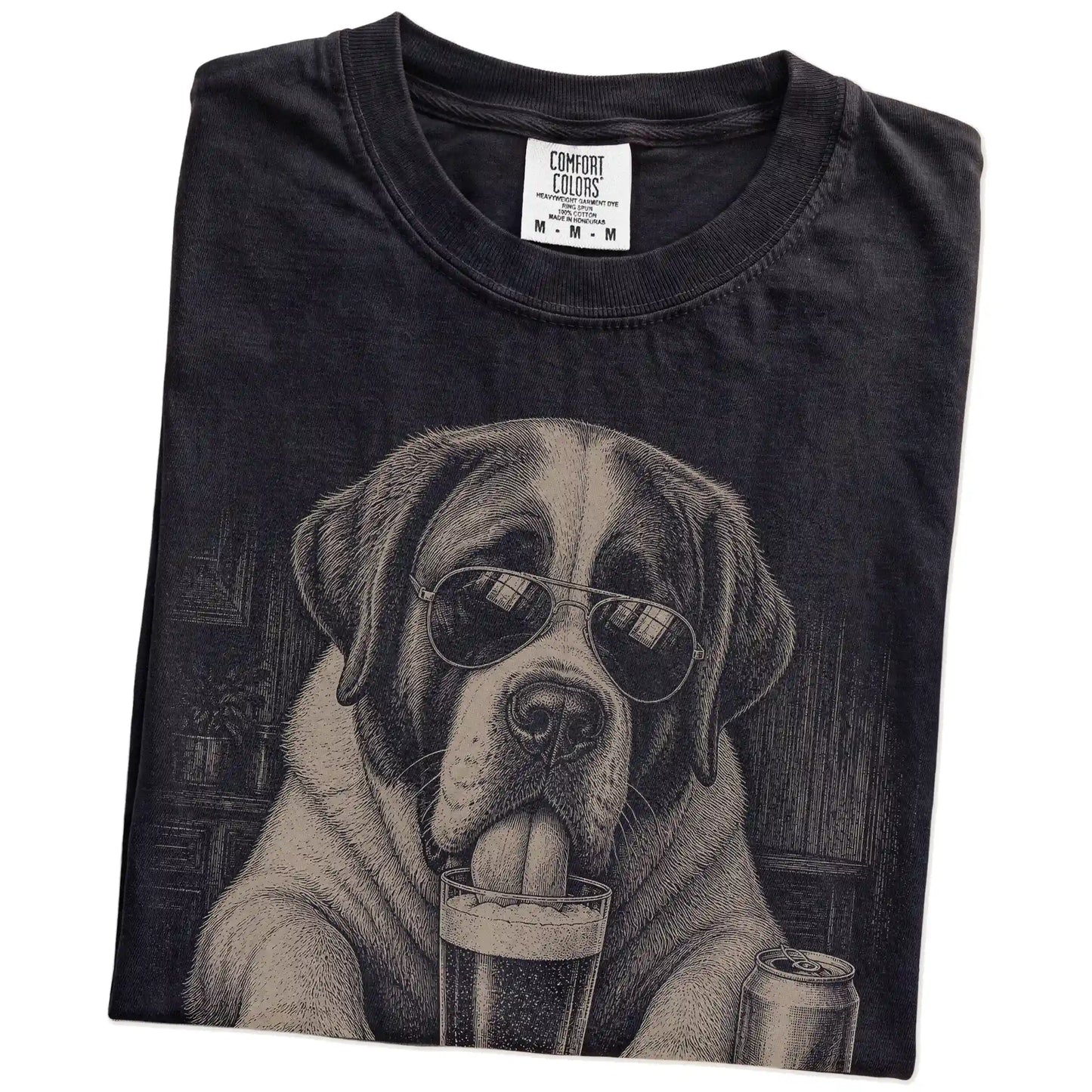 Folded Black Comfort Colors® t-shirt showing St Bernard sneaking a drink from a pint