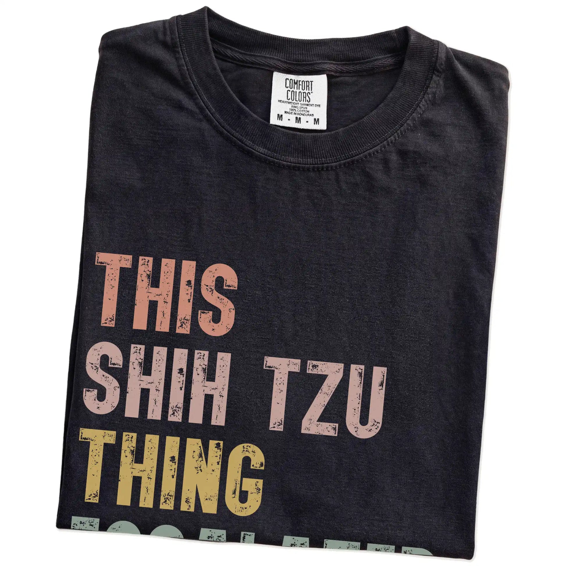 Folded Black Comfort Colors® T-shirt showing retro “This Shih Tzu Thing Escalated Quickly” lettering