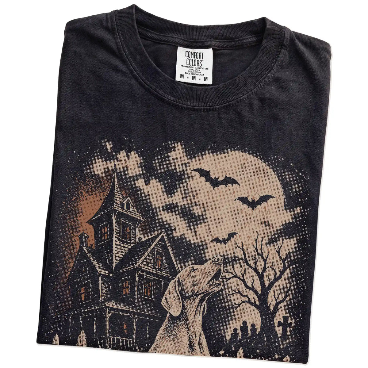 Folded Black Comfort Colors® T-shirt showing Weimaraner in a vintage haunted-house scene