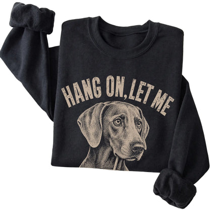 Black crewneck sweatshirt featuring Overthinking Weimaraner, folded presentation