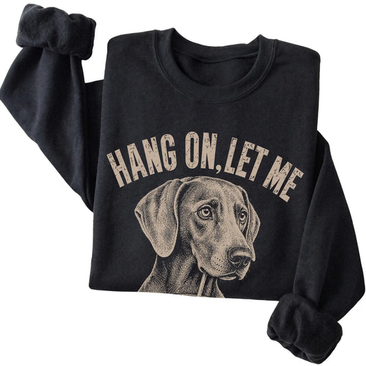 Black crewneck sweatshirt featuring Overthinking Weimaraner, folded presentation