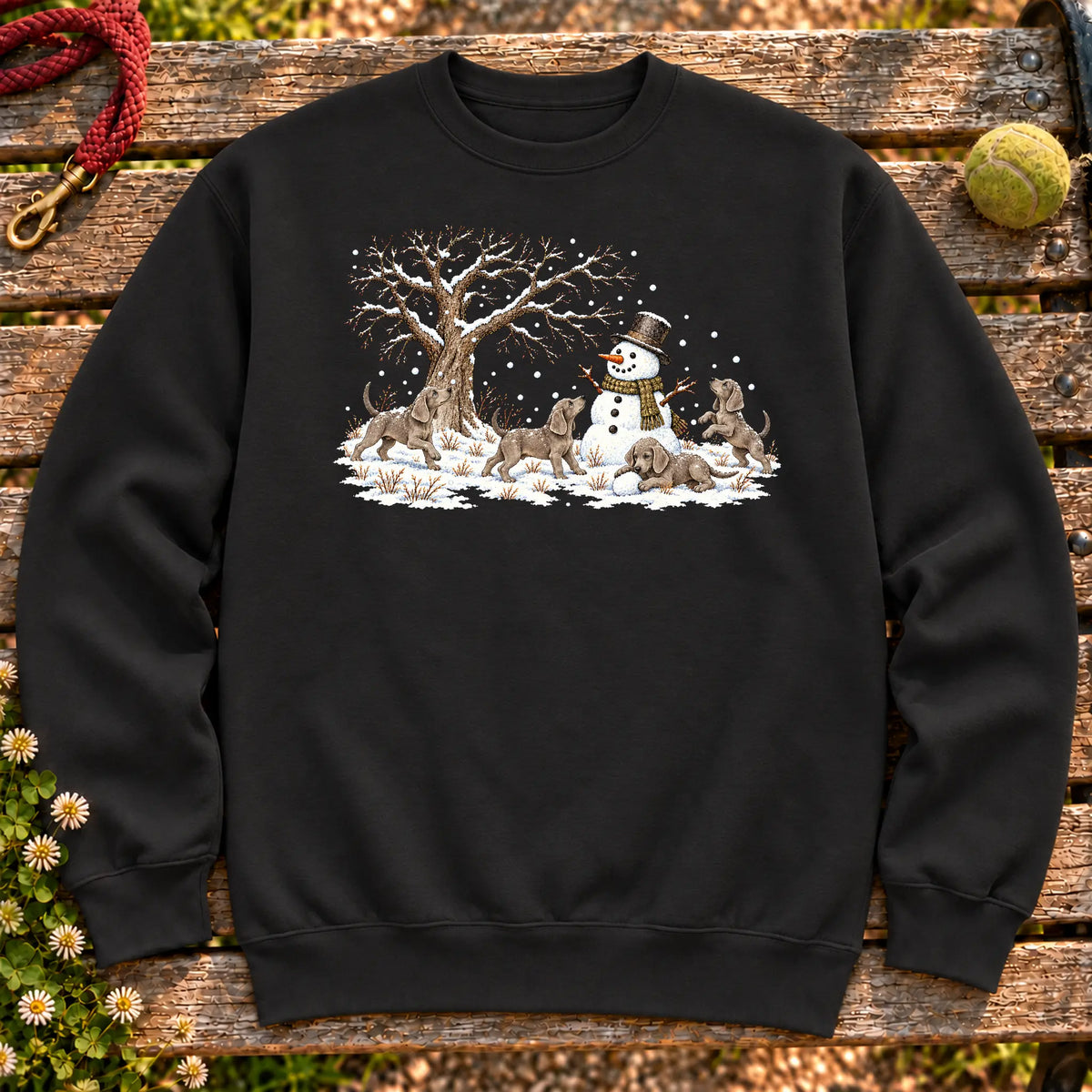 Weimaraner puppies playing in snow with a snowman on a Black sweatshirt