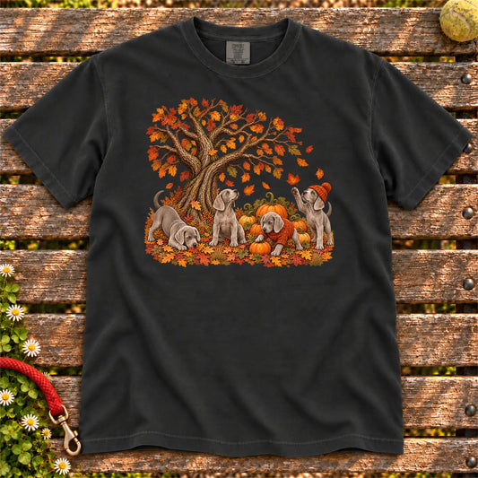 Four Weimaraner puppies with pumpkins beneath an autumn tree on a Black garment-dyed T-shirt