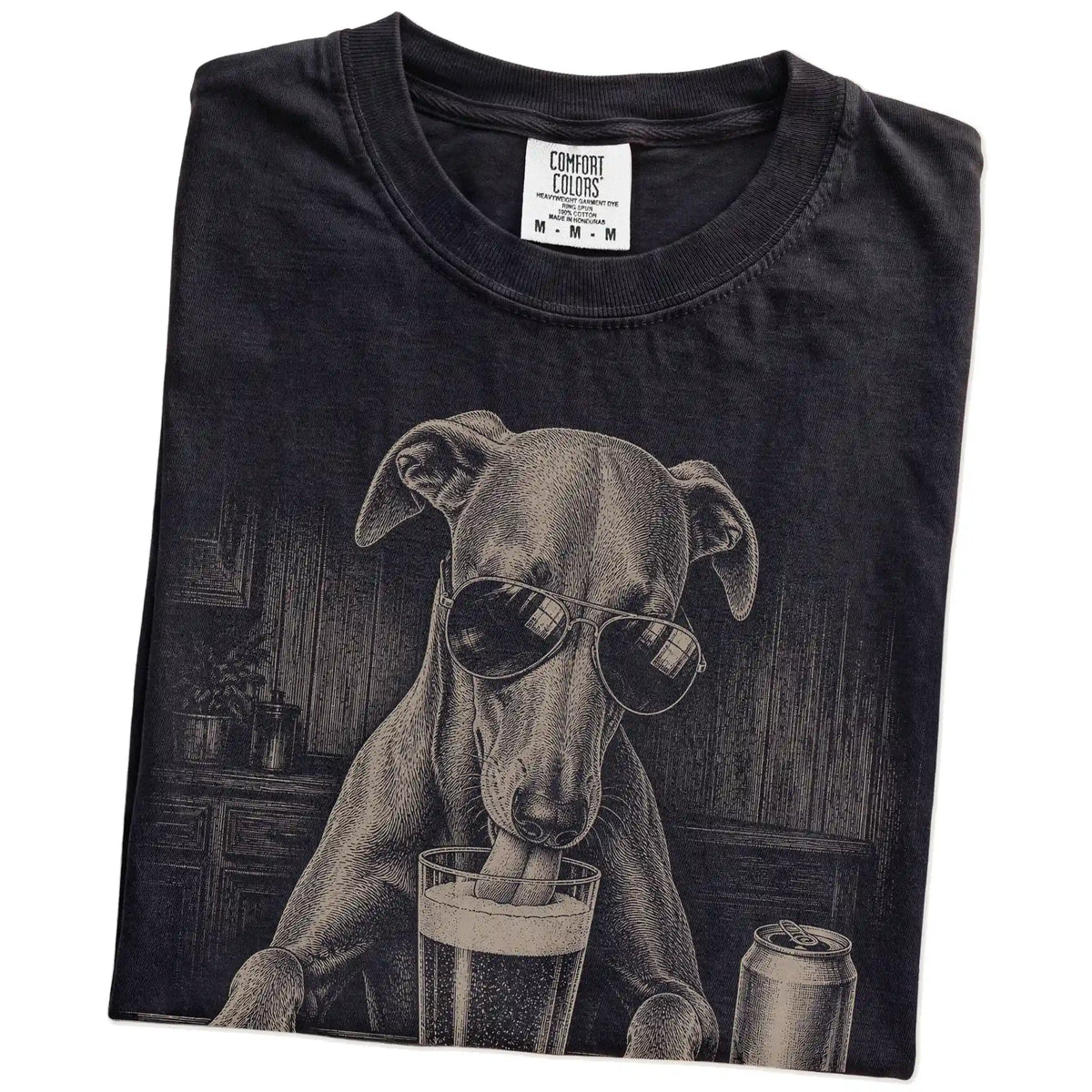 Folded Black Comfort Colors® t-shirt showing Whippet sneaking a drink from a pint