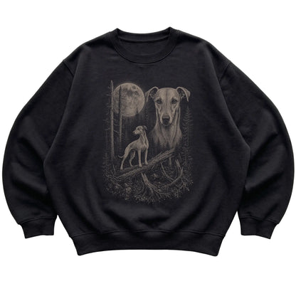 Whippet Moonlit Forest graphic on a black crewneck sweatshirt laid flat