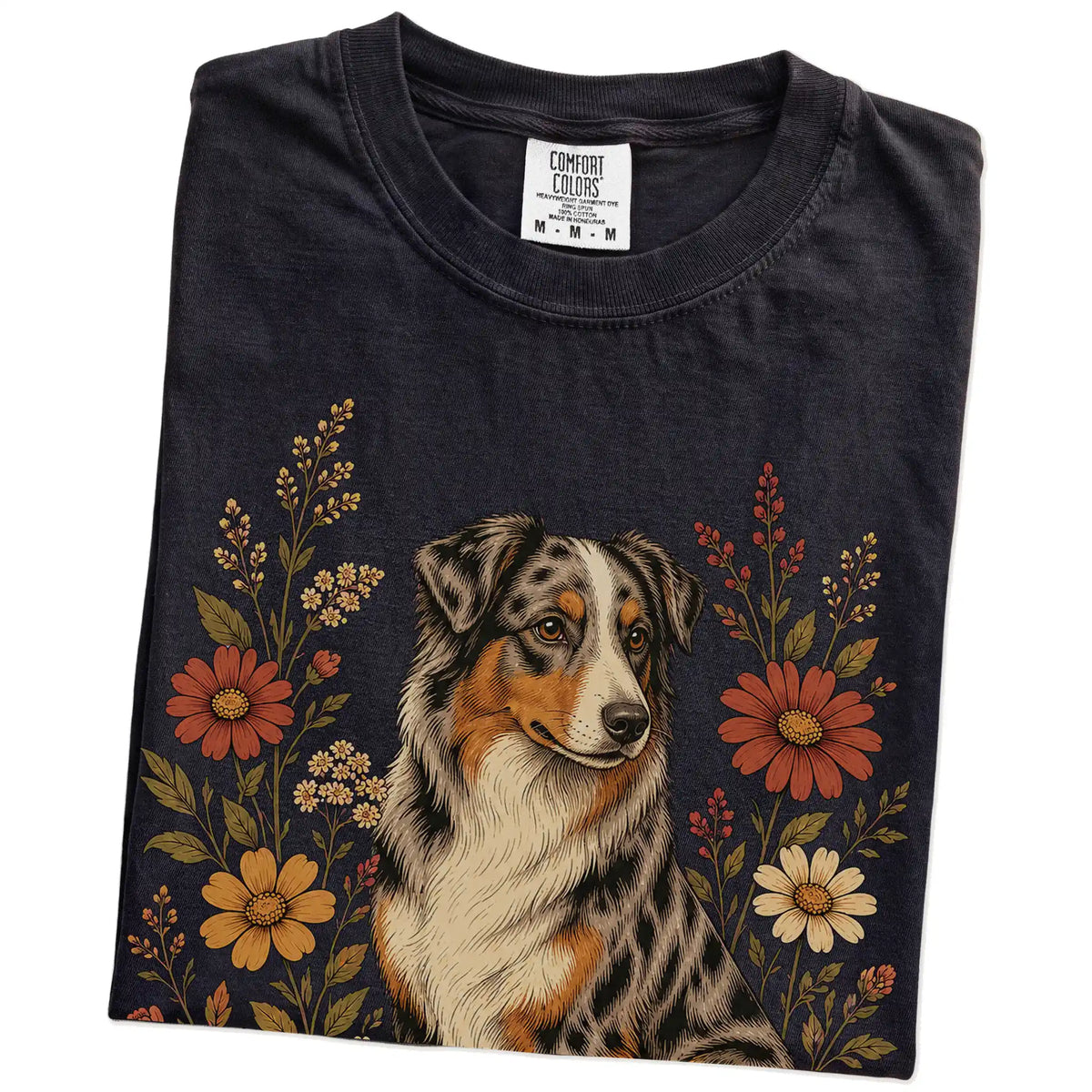 Folded Black Comfort Colors® T-shirt showing Australian Shepherd portrait surrounded by wildflowers beneath the moon