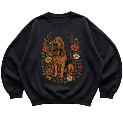 Black crewneck sweatshirt with Bloodhound portrait and wildflowers, flat lay