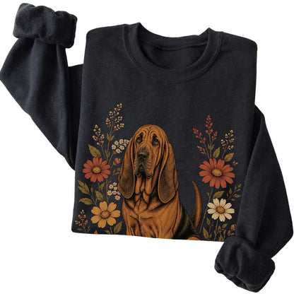 Black crewneck sweatshirt with Bloodhound portrait and wildflowers, folded view