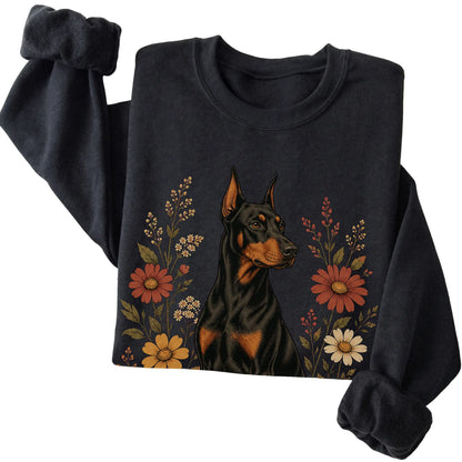 Black crewneck sweatshirt with Doberman portrait and wildflowers, folded view