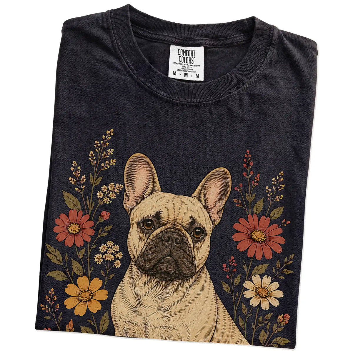Folded Black Comfort Colors® T-shirt showing French Bulldog portrait surrounded by wildflowers beneath the moon