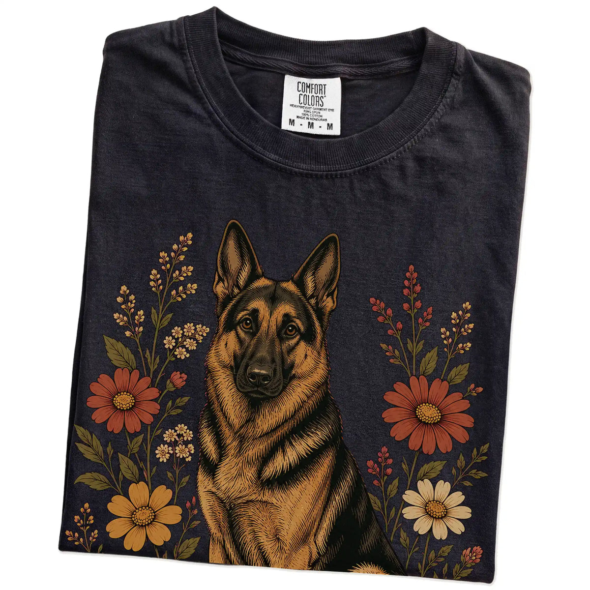 Folded Black Comfort Colors® T-shirt showing German Shepherd portrait surrounded by wildflowers beneath the moon