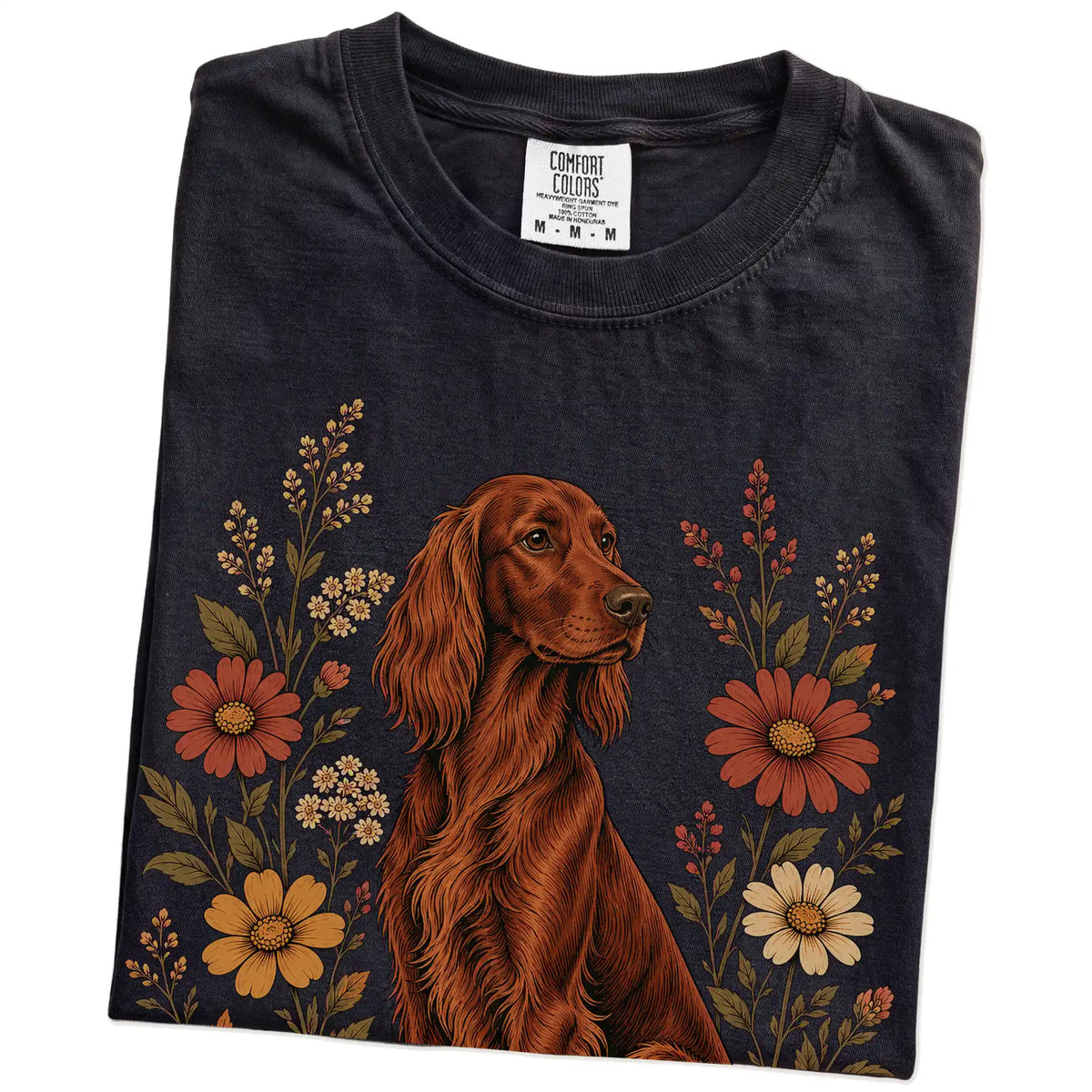 Folded Black Comfort Colors® T-shirt showing Irish Setter portrait surrounded by wildflowers beneath the moon