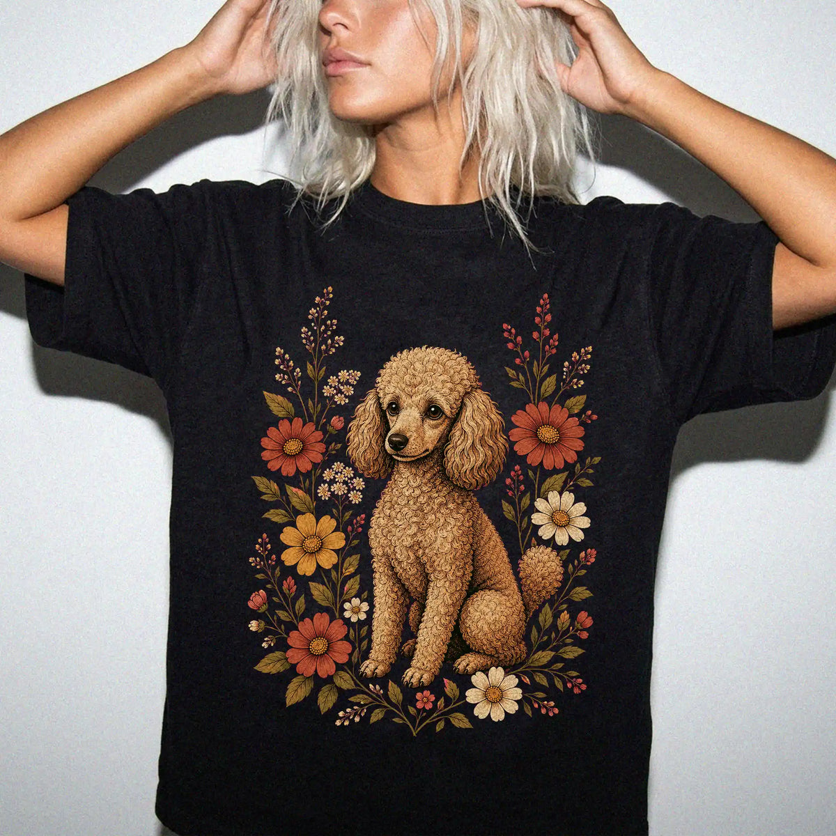 Model wearing a Black Comfort Colors® T-shirt showing Poodle portrait surrounded by wildflowers beneath the moon