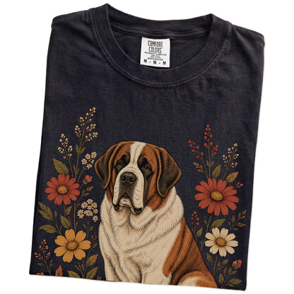Folded Black Comfort Colors® T-shirt showing Saint Bernard portrait surrounded by wildflowers beneath the moon