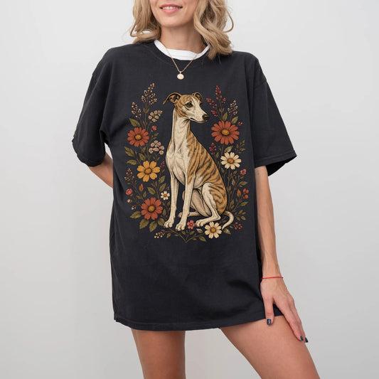 Model wearing a Black Comfort Colors® T-shirt showing Whippet portrait surrounded by wildflowers beneath the moon