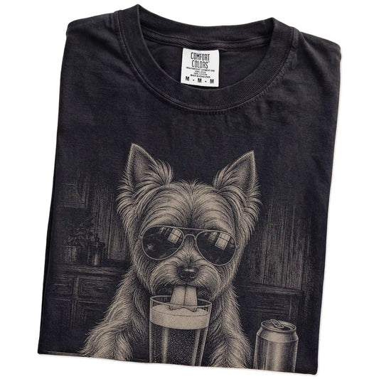 Folded Black Comfort Colors® t-shirt showing Yorkie sneaking a drink from a pint
