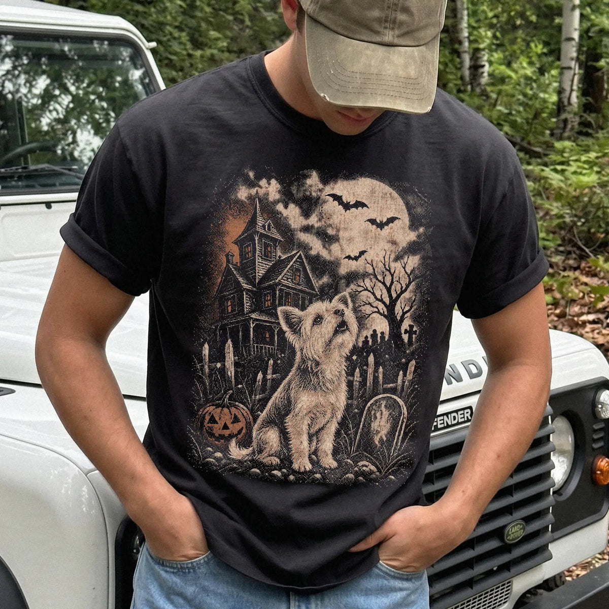Model wearing a Black Comfort Colors® T-shirt showing Yorkie in a vintage haunted-house scene