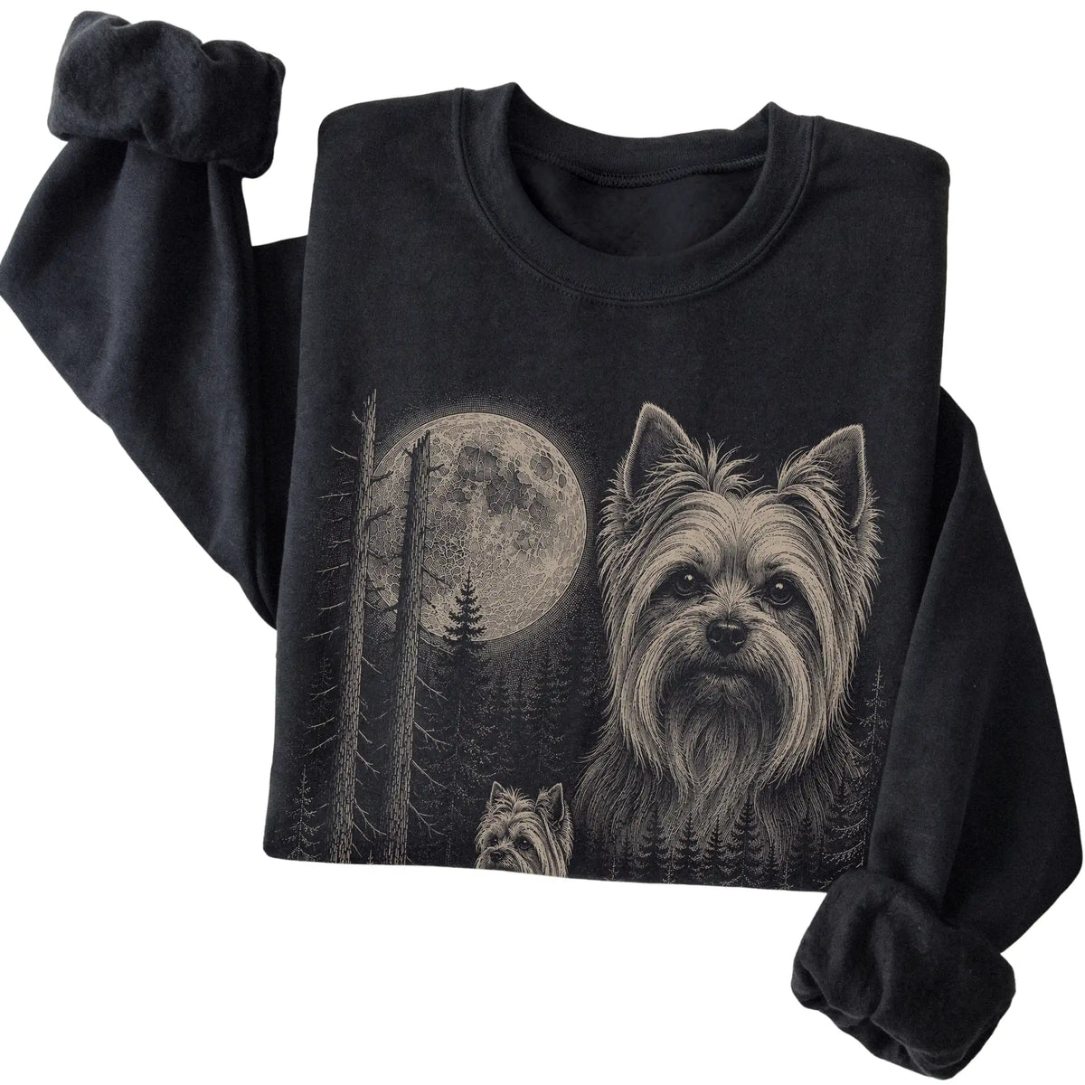 Folded black crewneck sweatshirt showing the Yorkie Moonlit Forest graphic