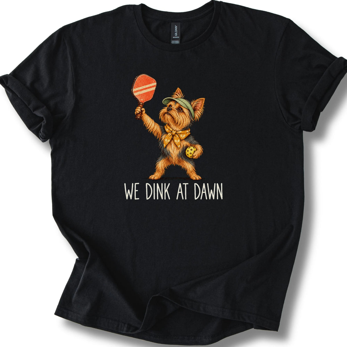 Yorkie with a pickleball paddle and ball on a Black Gildan® T-shirt with We Dink at Dawn text