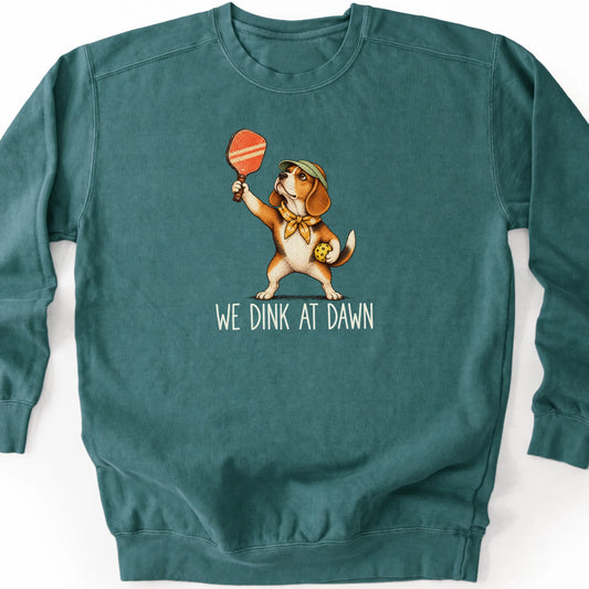 Beagle with a pickleball paddle and ball on a Blue Spruce Comfort Colors® sweatshirt with We Dink at Dawn text